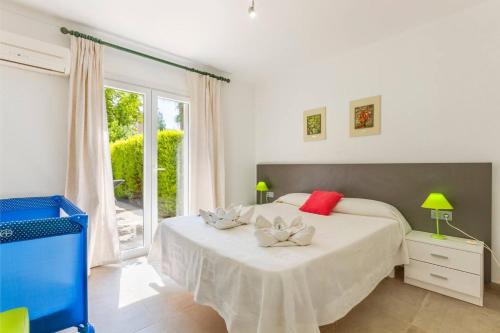 a bedroom with a bed with red and white pillows on it at Playamar in Alcudia