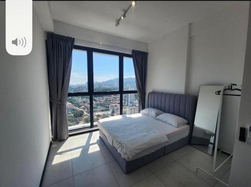 a bedroom with a bed and a large window at Urban Suite the Privilege Suites by Merveille in George Town