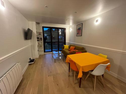a living room with a yellow table and a couch at Suresnes 3 cozy rooms refurbished and parking! in Suresnes