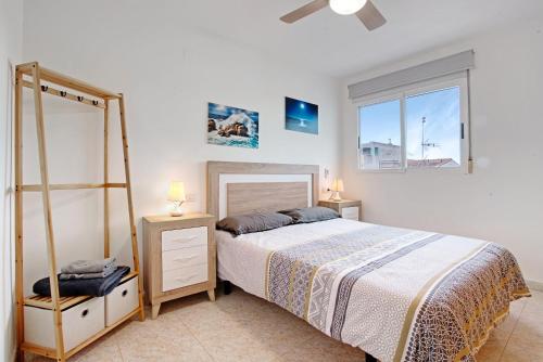 a bedroom with a large bed and a window at Casa Pera in Xilxes