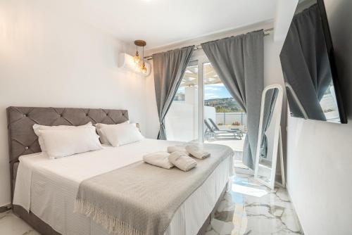 a bedroom with a bed with two towels on it at Punta Mare Villa 3 in Karpathos Town