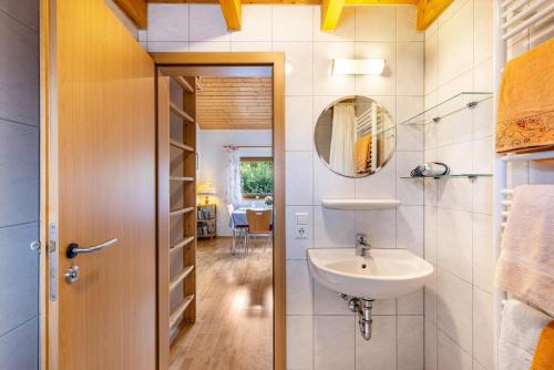 une salle de bain avec un lavabo et un miroir dans l'établissement Ferienhaus Katrin, à Bad Urach