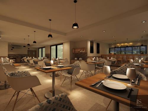 a restaurant with tables and chairs in a room at Zone by The Park New Market Kolkata in Kolkata