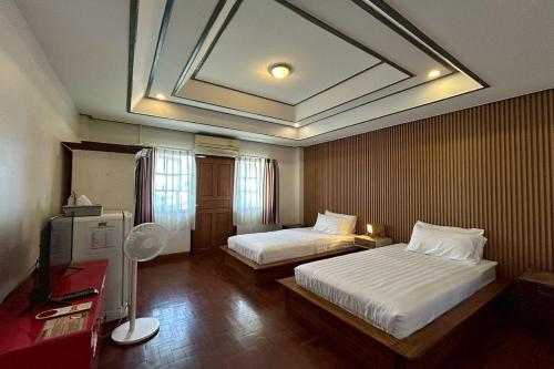a hotel room with two beds and a skylight at Norn-Nanta House in Chiang Mai