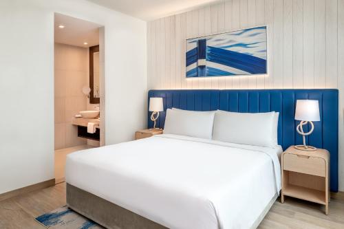 a bedroom with a large bed with a blue headboard at Crowne Plaza Yas Island by IHG in Abu Dhabi