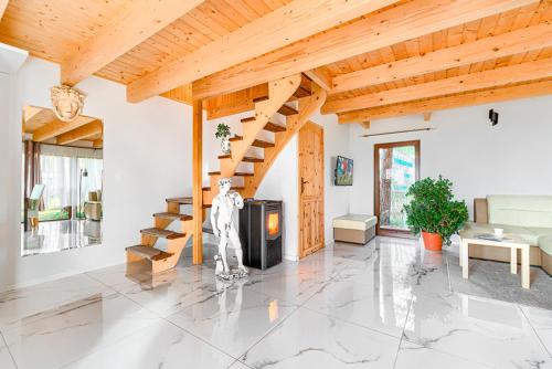 ドンプキにあるFH Romaniuk Nr 5の木製の天井と階段のあるリビングルーム