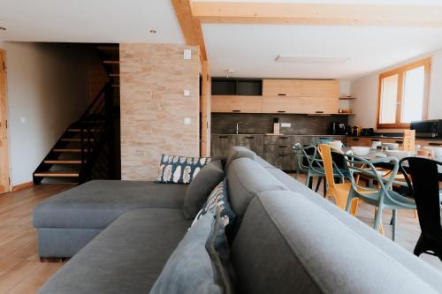 a living room with a couch and a dining room at Germain Ski Lodge in La Toussuire