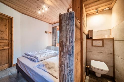 a small bedroom with a bed and a toilet at Bel Appartement - Sixt Fer cheval in Sixt