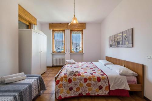 a bedroom with a bed and a refrigerator at Casa Vacanze Elma in Bussolengo