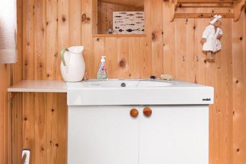 a bathroom with a white sink and a vase on a counter at Cabin - Sleeps 6 - Pets Ok - Pato - Parking in Ørnes
