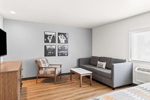 a living room with a couch and a chair at Maverick Hotel Eugene Near University, an Ascend Collection Hotel in Eugene