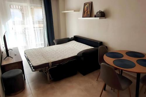 una pequeña habitación con una cama y una mesa en Antina 12 en Santa Pola, en Santa Pola