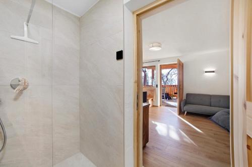 a bathroom with a shower with a glass door at Hauserhof in Lagundo