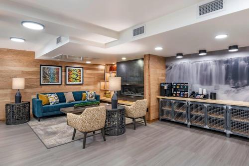 a living room with a couch and a table and chairs at The Gibson Hotel Great Falls, an Ascend Collection Hotel in Great Falls