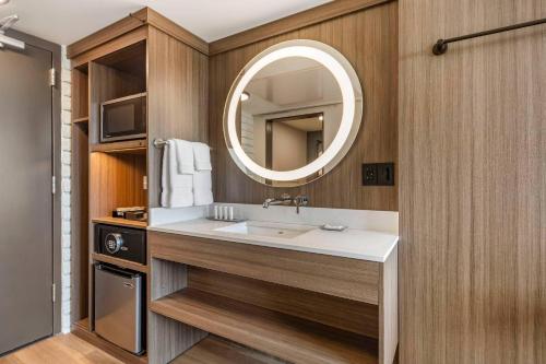 a bathroom with a sink and a mirror at The Gibson Hotel Great Falls, an Ascend Collection Hotel in Great Falls