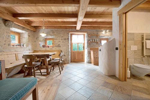 a kitchen with a table and a sink and a toilet at Chalet Bio Wild in Bocenago