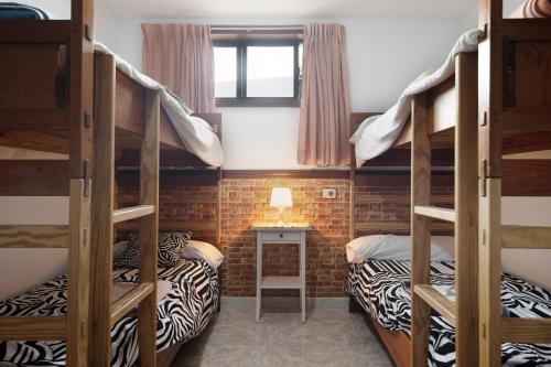 En eller flere senge i et værelse på Bungalow Famara, Lanzarote