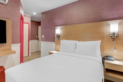 a hotel room with a bed and a tv at The Mayfair Hotel Times Square, an Ascend Collection in New York