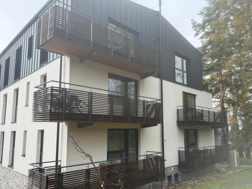 a building with balconies on the side of it at Apartmán Forest, Tatranská Štrba in Tatranska Strba