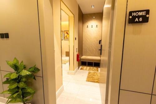 a hallway with a home sign on the door at استوديو فاخر بتصميم عصري in Riyadh