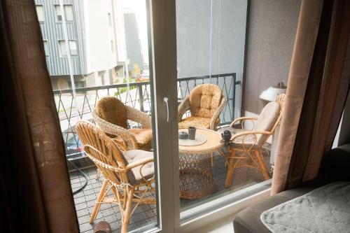 ビイェラシュニツァにあるApartment Bjelasnica Vucica Lodgeのテーブルと椅子のあるバルコニー付きの部屋