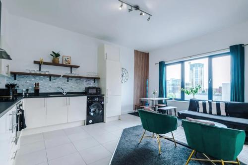 a kitchen and living room with a couch and a table at Propti in Manchester