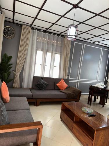a living room with a couch and a coffee table at The K Residence in Kampala
