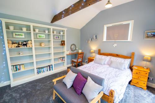 a bedroom with a bed and a couch at The Den - Winchelsea in Winchelsea