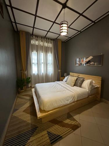 a bedroom with a large bed in a room at The K Residence in Kampala