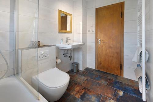 a bathroom with a toilet and a sink and a shower at Fewo Harzwichtel am Waldesrand in Braunlage