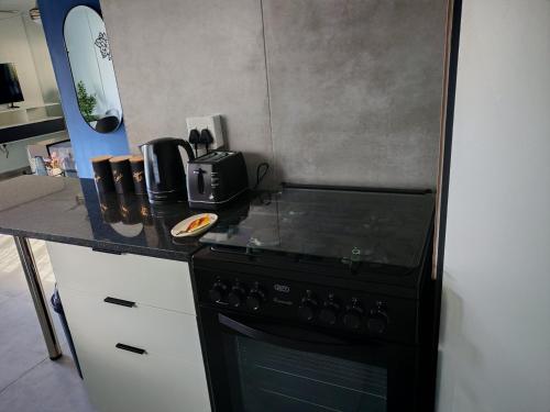 a kitchen with a black stove and a counter top at Kingsmead Haven in Durban