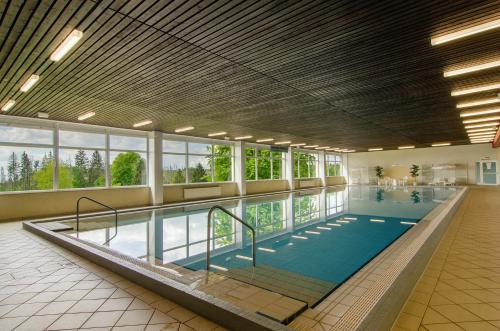 a large indoor swimming pool in a building at Superior App 229 mit Pool und Sauna in Braunlage