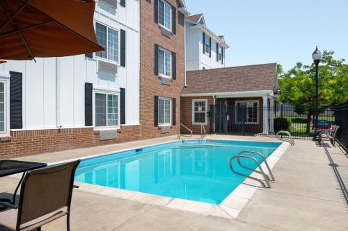 a swimming pool in front of a building at TownePlace Suites Salt Lake City Layton in Layton
