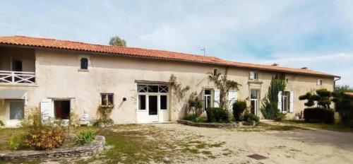a large white building with a yard in front of it at Terre Happy in Ribérac
