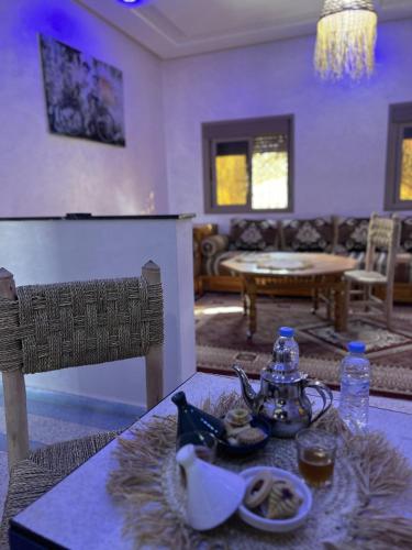 a living room with a table with a tea set on it at Oasis apartment in Ouarzazate
