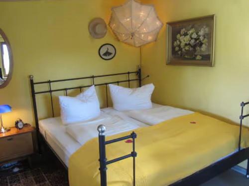 a bedroom with a bed with white pillows on it at Charlottes Landlust in Ribnitz-Damgarten