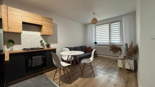 a kitchen and living room with a table and chairs at Tabago Studio 37 Wodzisław in Wodzisław Śląski
