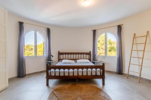 モライラにあるFantastisic villa - Great locationのベッドと2つの窓がある寝室