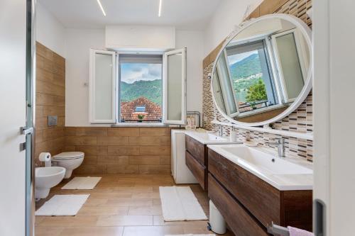 a bathroom with two sinks and a mirror at Casa Lago Vicky in Omegna