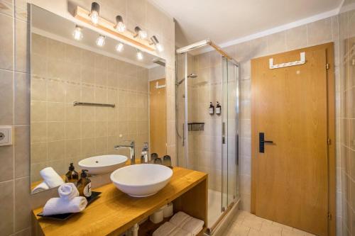 a bathroom with a sink and a shower at Mountain Residence Kasern Nr 2 in Predoi