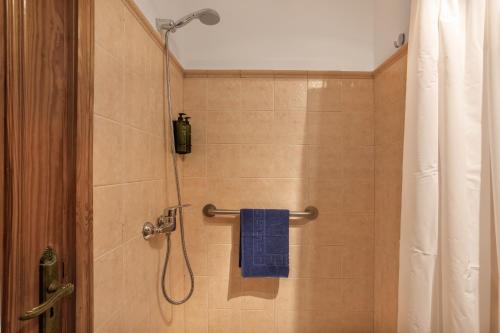 a shower with a blue towel in a bathroom at Casa Abuela Maruca in Corralejo