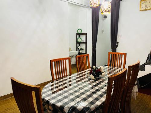 a dining room table with a black and white checkered table cloth at Pagoda Guest Nugegoda in Sri Jayewardenepura Kotte