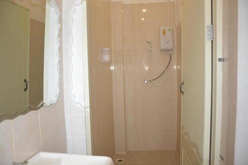 a bathroom with a shower and a sink at Grace Hostel - Chiang Rai in Chiang Rai