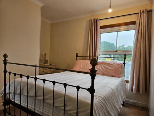 a bedroom with a bed and a window at B&B Rooms in terraced house in Sudbury centre in Sudbury