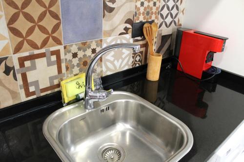 a kitchen sink with a faucet in a kitchen at SM Apartments Station in Lleida