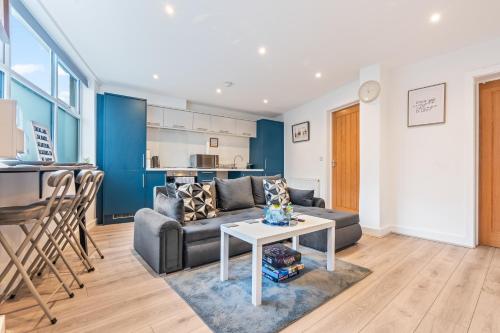 ノッティンガムにあるModern 2BR Central Apartment Sleeps 7 Walk to Shops & Arenaのソファとテーブルのあるリビングルーム