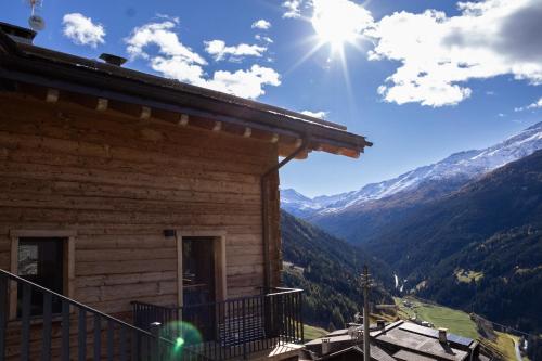 a log cabin with a view of the mountains at Gran Zebrú B&B - high mountain in Valfurva