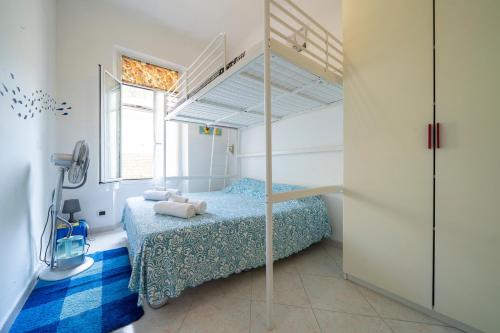 a small bedroom with a bed with a bunk bed at Villa Verde - 300m From Sea in Bordighera