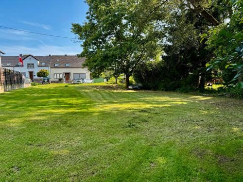 an empty yard with a house and trees at Lot54 Deluxe Apartements in Neidenbach