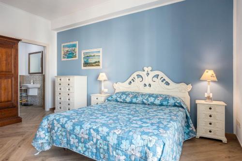 a blue bedroom with a bed and two night stands at Matilde - Isola delle Femmine in Isola delle Femmine